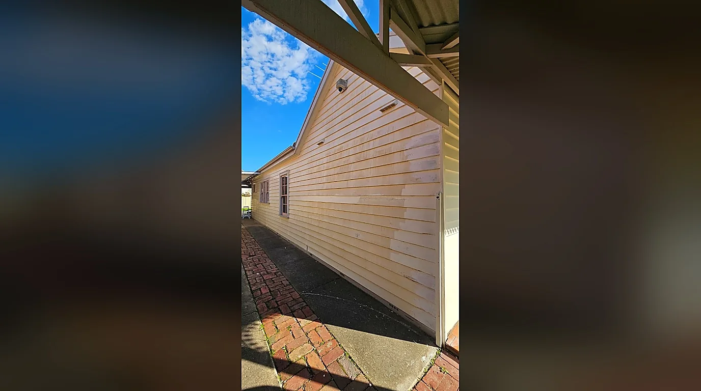 Weathered and patchy weatherboards before painting